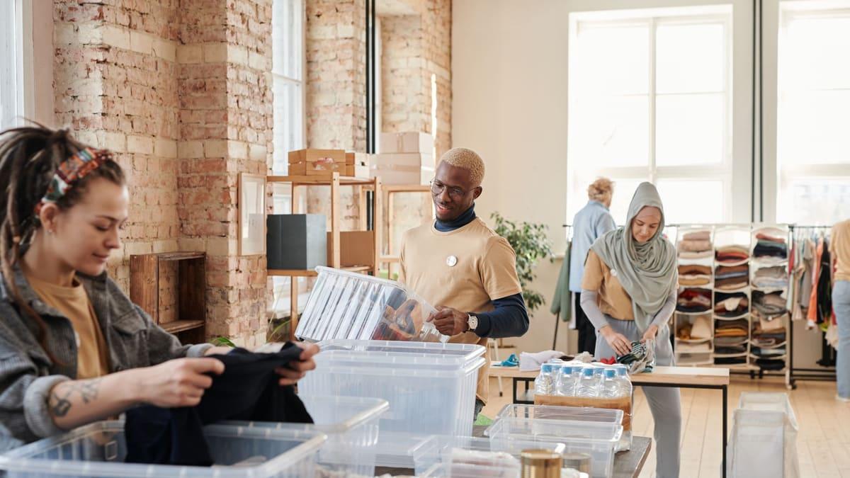 Volunteers sorting boxes of donations in a community hall