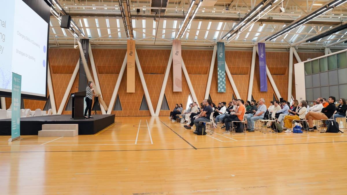 Residents seated at a community meeting in a local town hall